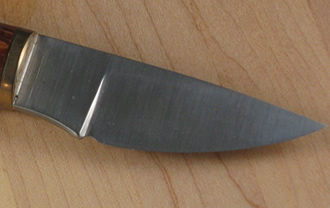 knife with oak handle blade closeup